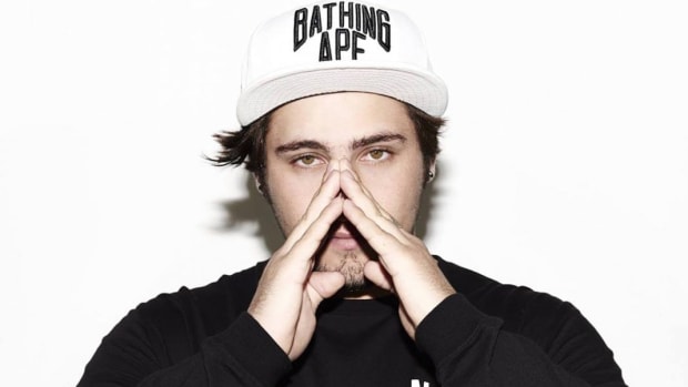 A photo of Jauz (real name Sam Vogel) putting his hands up to his face.