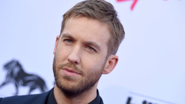 Photo of Scottish DJ/producer Calvin Harris in front of a splash with Billboard's logo on it.