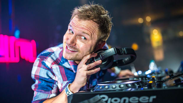 Former Dash Berlin frontman Jeffrey Sutorius playing with a pair of headphones during a DJ performance.