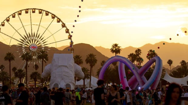 A photo of the ferris wheel and astronaut installation at Coachella Valley Music & Arts Festival.