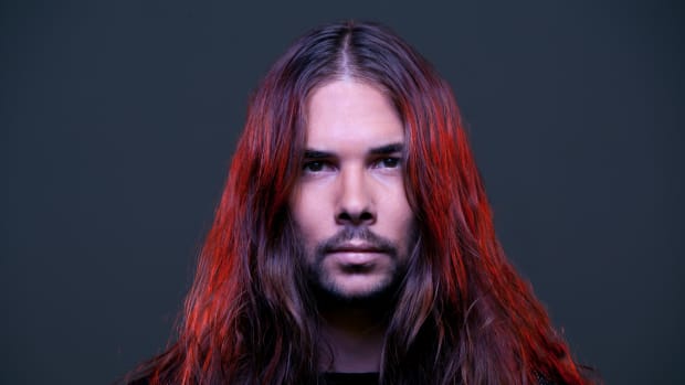A head shot of DJ/producer Seven Lions A.K.A. Jeff Montalvo with bright red dyed hair.