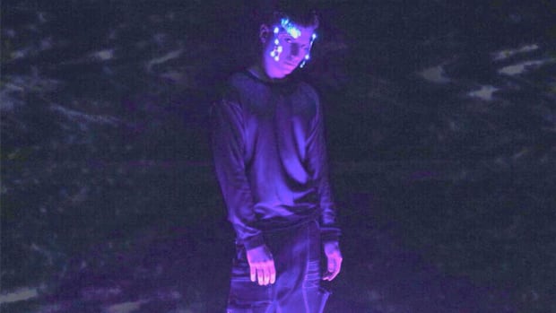 Nytrix press photo showing him wearing futuristic headgear in purple lighting.