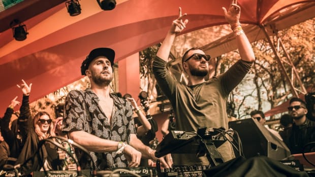 A photo of DJ/producers FISHER and Chris Lake behind the decks during a performance.