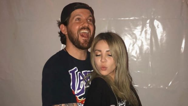 A candid photo of Dillon Francis hugging Alison Wonderland while making a funny face.