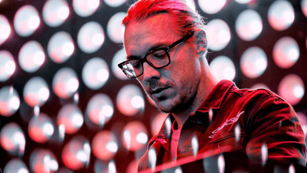 A color photo of DJ/producer Diplo (real name Thomas Wesley Pentz) during a performance.