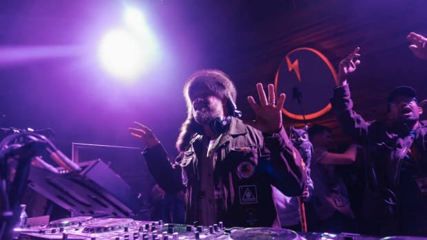 Claude VonStroke performing in front of the Dirtybird logo.