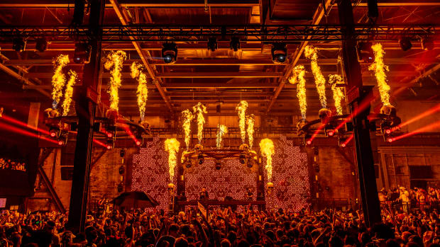 Pyrotechnics blaze from skull-adorned chandeliers at The Great Hell stage.