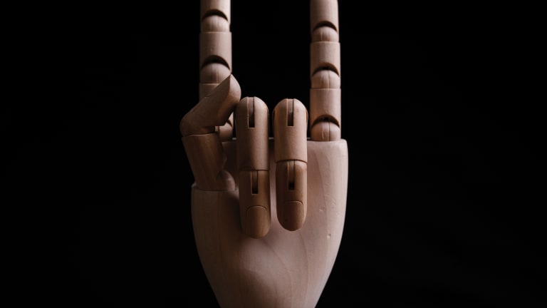 Wooden Mannequin Fake Hand Pointing Finger Up As To Ask A Question