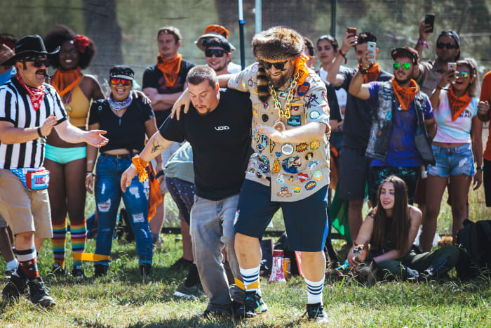 A camper gets cheered on by his campmates in the three-legged race with Claude VonStroke.