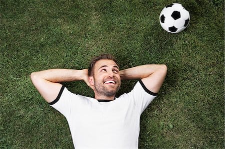 To kill two recovery birds with one stone, go outside and lay down. Soak up the sunlight while resting your muscles