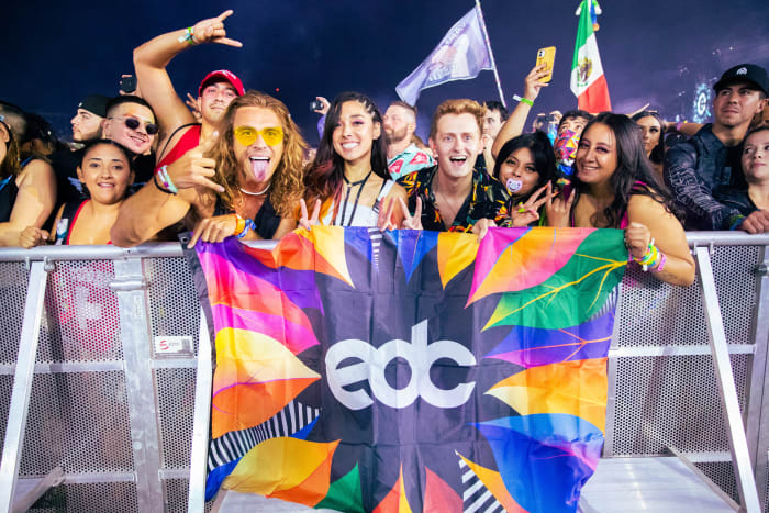 EDC Vegas 2021 attendees pose on the rail of the Circuit Grounds stage.