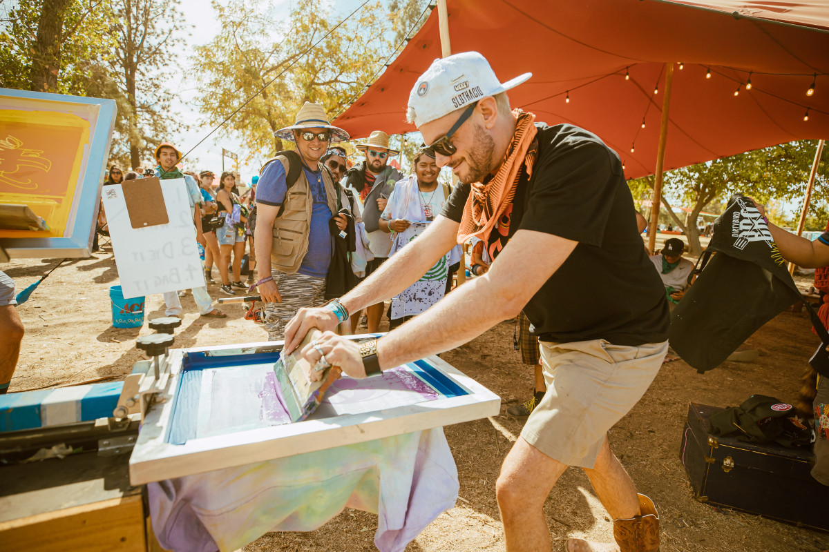 Sacha Robotti seen screenprinting a souvenir 