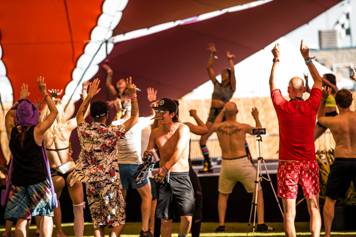 EDC Vegas 2021 attendees dance underneath the Sol tent on the Mesa.