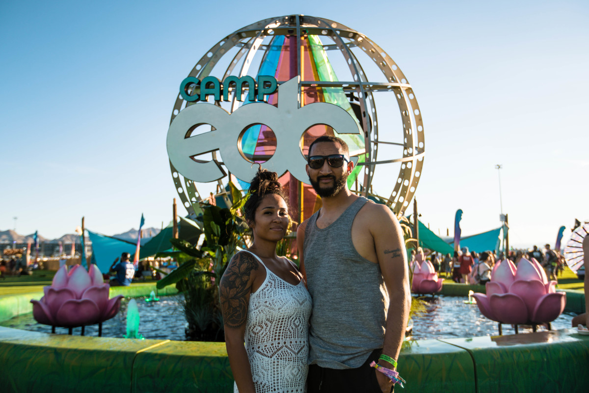EDC Vegas 2021 attendees pose in front of the Camp EDC sign on the Mesa.