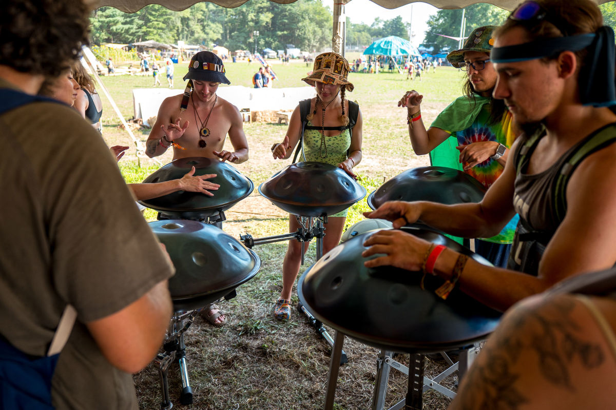 Festival attendees learning how to play handpans for an interactive Soulshine workshop.