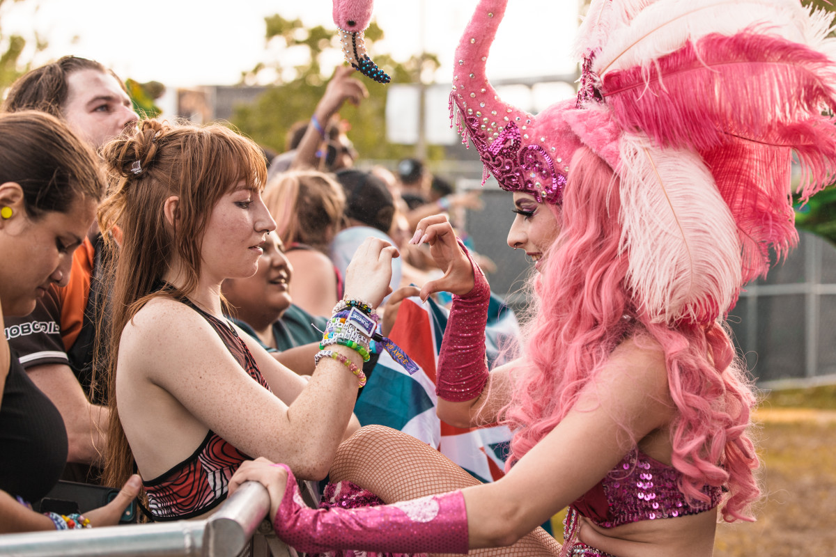 A performer from the Phoebe Samba Team interacting with fans.