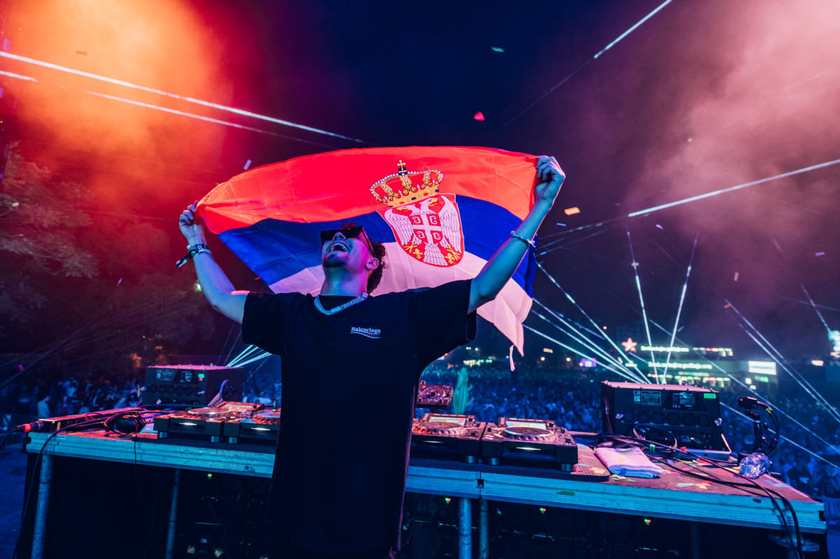 ACRAZE holds the Serbian flag while performing at EXIT Festival 2022.