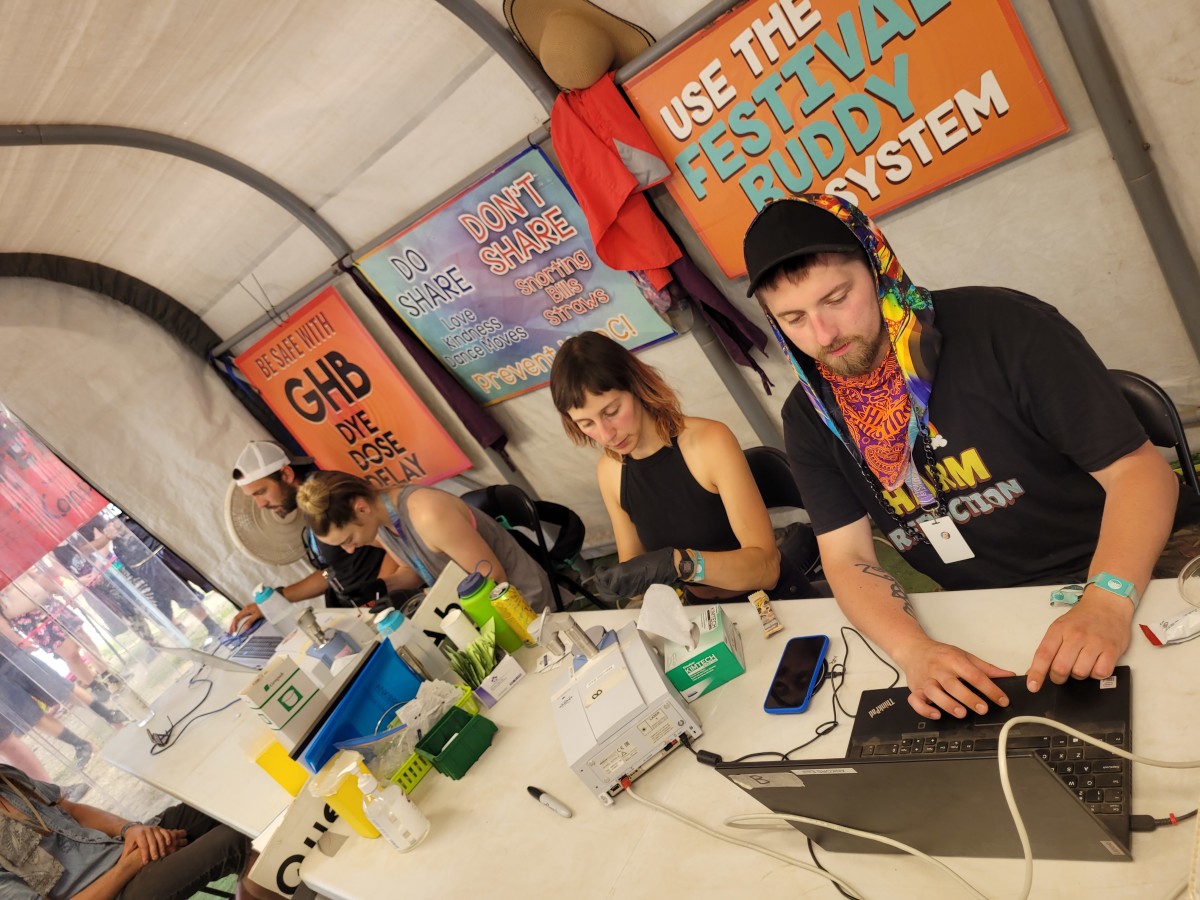 Harm reduction workers and technicians work side-by-side in the ANKORS drug checking tent at Shambhala
